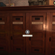 Four wooden firehouse lockers that read E. Spengler, R. Stantz, P. Venkman, and W. Zeddemore.